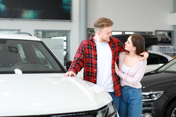 Couple choosing new car in salon