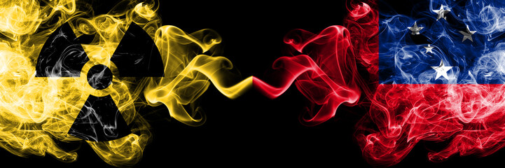 Samoa, Samoan vs nuclear smoky mystic flags placed side by side. Thick colored silky smokes combination of Samoa, Samoan flag and radioactive sign.