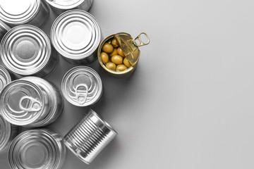Tin cans with food on grey background