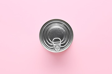 Tin can with food on color background