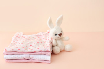 Obraz premium Stack of baby clothes on color background