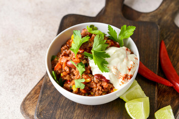 Bowl with tasty chili con carne on table