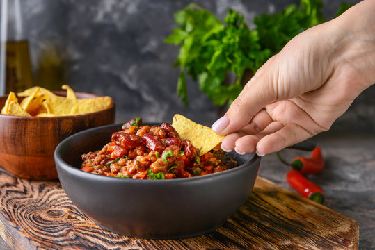 Woman Eating Tasty Chili Con Carne With Nachos