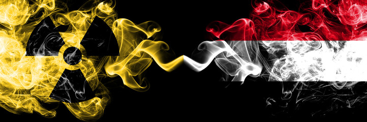 Yemen, Yemeni vs nuclear smoky mystic flags placed side by side. Thick colored silky smokes combination of Yemen, Yemeni flag and radioactive sign.