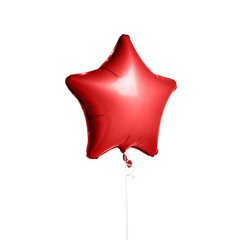 Big red metallic latex star balloon for birthday party isolated on a white 