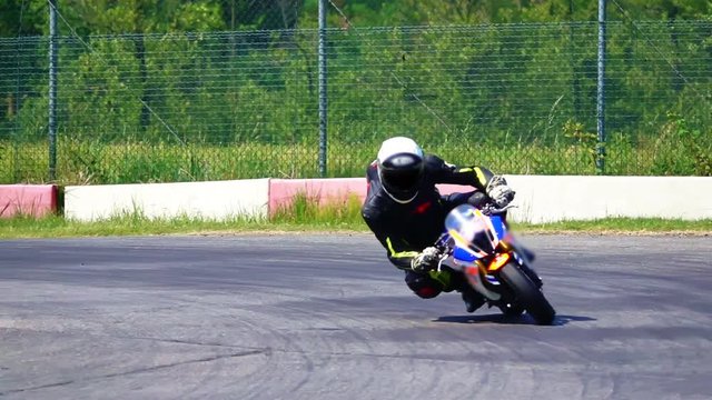 Fast motorcycle on motorsport circuit track