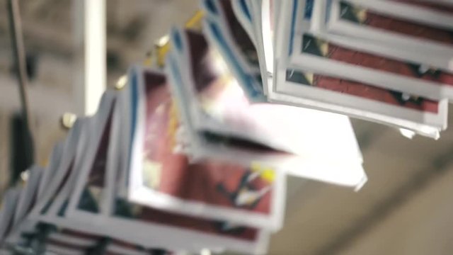 Close up view on conveyor belt with newspapers at typography. process of making newspapers at printing house