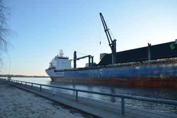 Toronto's harbour bay's at sunset with a cargo ship