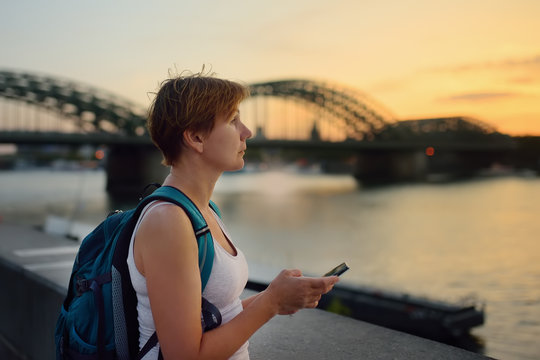 Mature women admire amazing sunset view of Cologne, Germany.