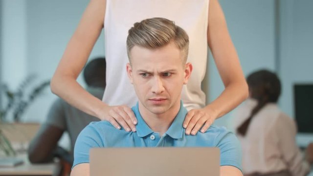 Closeup woman hands making massage to man. Shocked man asking to stop harassment