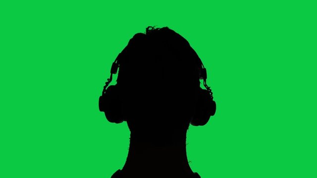 Man with headphones silhouette, green screen