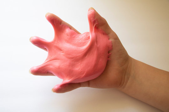 Hands Manipulating Pink Slime Hands Pulling, Twisting, Squeezing Slime. Slime Resembles Bubble Gum. Gooey, Stretchy, Flexible, Satisfying, Tactile Experience. Gross Texture. Childhood Fun. Innocent Pl