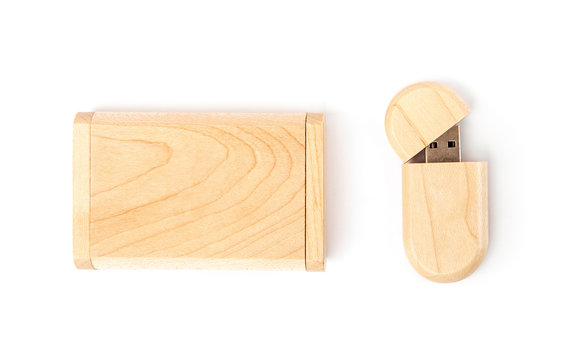 Opened USB flash drive in a wooden case next to a gift wooden box. Isolated on white background.