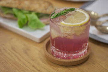 butterfly pea Mocktail with green mint and lime on wood table