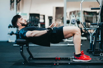Man training glutes in the gym