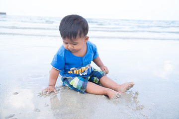 cute little baby boy play on the beach