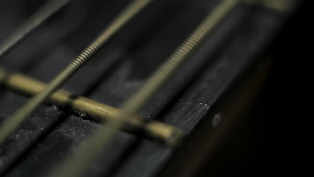 Guitar string vibrating creating wave Macro extreme close up shallow