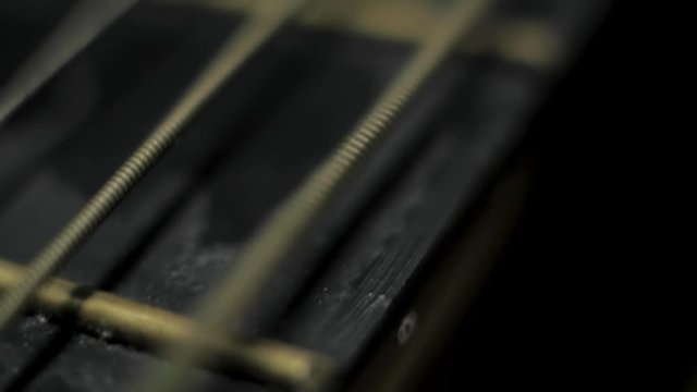 Moving old retro dirty antique Guitar string vibrating creating wave Macro