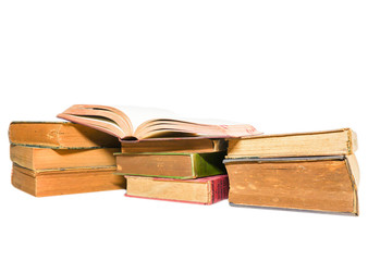Old books stacked and isolated on white background.