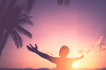 Copy space of man raise hand up on sunset sky at beach and island with palm tree abstract background.
