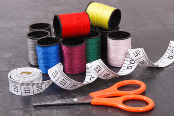 Spools of thread, tape measure and scissors. Accessories for embroidery and sewing