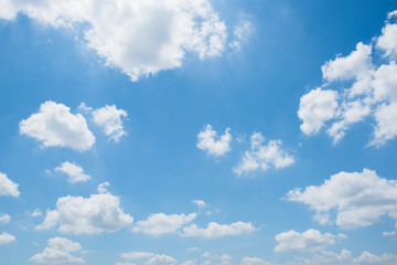 White clouds on a bright day with a blue sky in the background