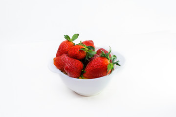 strawberries in a white Cup on a white background