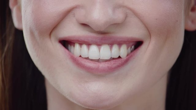 Close up woman mouth smiling happy beautiful soft lips teeth perfect dental health face attractive female happy health cosmetics young slow motion