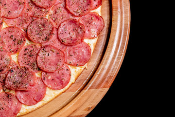 Half a pizza on top of a black background in close up