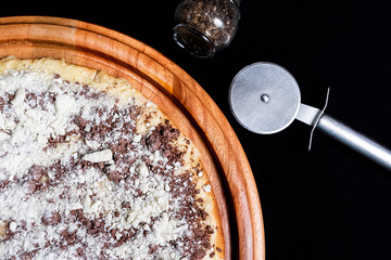 Half a pizza on top of a black background in close up