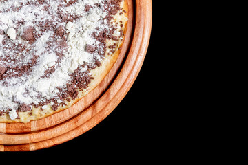 Half a pizza on top of a black background in close up