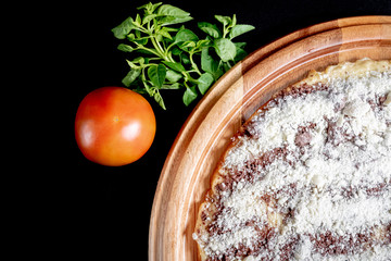 Half a pizza on top of a black background in close up