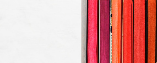 Pile of books with color stack on white background. Copy space