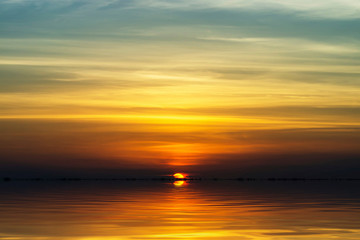Naklejka na ściany i meble Sunset sky at the lake in golden hour.