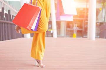 Beautiful women with shopping bags enjoying in shopping standing outdoors of shopping mall, shopping concept