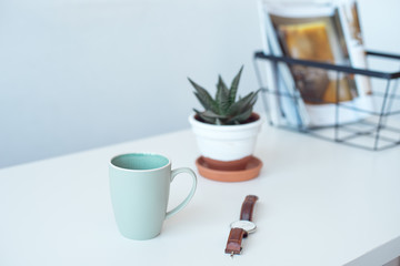 White desk table with copy space, supplies and coffee mug. Front view workspace and copy space