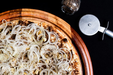 Half a pizza on top of a black background in close up