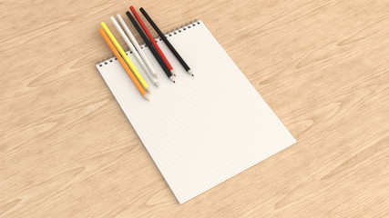 Notebook with colorful pencils