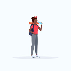 Woman hiker with backpack drinking water African