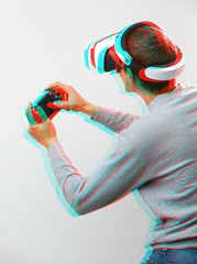 Man with virtual reality headset is playing game. Image with glitch effect.