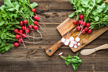 Bio organic vegetables. Fresh red radish on cutting board. Clean vegetables, harvested freshly...