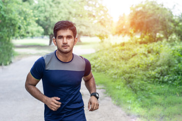 Fototapeta premium Athletic young man running in the sports ground. Healthy lifestyle , fitness and sports concept.