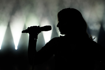 Singer in silhouette. Close up image of live singer on stage