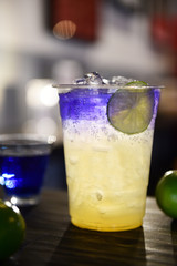 close up of iced butterfly pea juice with honey, lime and soda water on the table