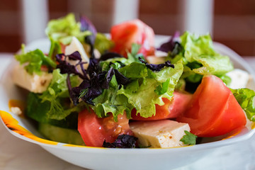 Greek salad with fresh vegetables in plate close