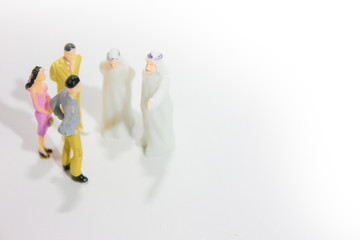 Group ofminiature businessman and arabian businessman isolated white background.	
