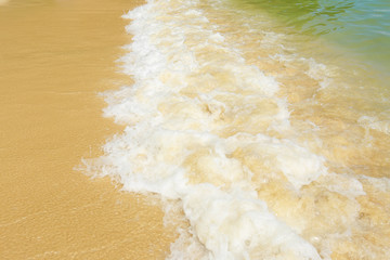 Soft wave of blue ocean on sandy beach. Background.