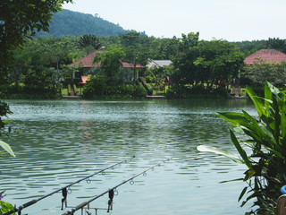 Fishing resort  Asia, Buddhist temple at garden next to the lake  in Krabi, Thailand