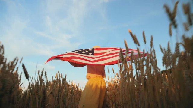 The girl with the flag of America in the field