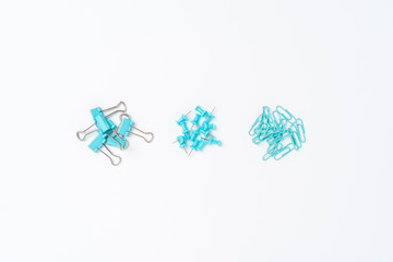 Various kinds of paper clips and drawing pins. Top view